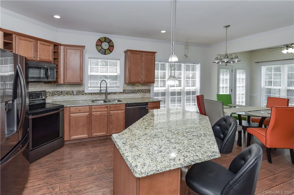 2425 Lakeview Circle Matthews, NC 28105 - Photo 14 of 33 a kitchen with stainless steel appliances granite countertop sink stove top oven and cabinets