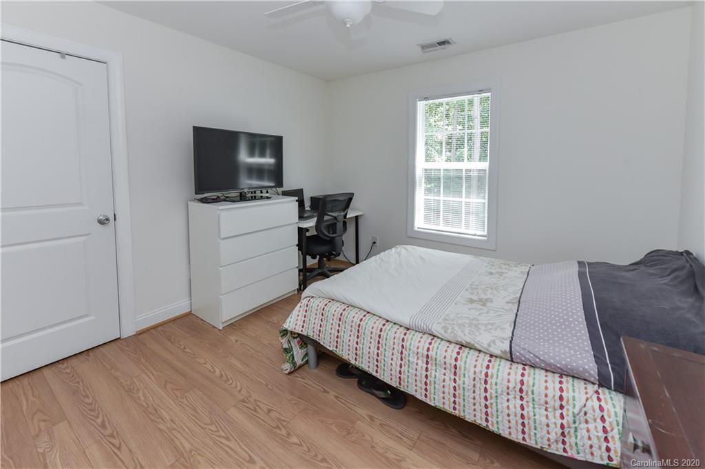 2425 Lakeview Circle Matthews, NC 28105 - Photo 18 of 33 a bedroom with a bed and a flat screen tv