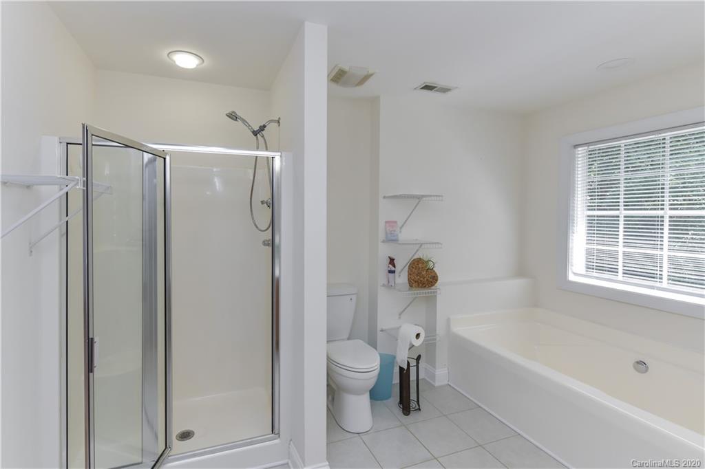 2425 Lakeview Circle Matthews, NC 28105 - Photo 22 of 33 a bathroom with a shower a toilet and a bathtub