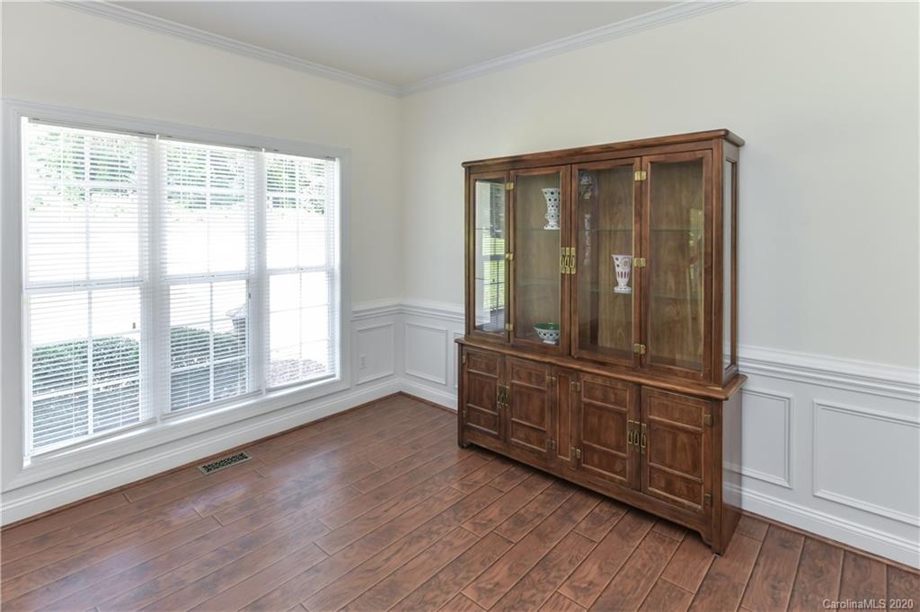 2425 Lakeview Circle Matthews, NC 28105 - Photo 4 of 33 an empty room with wooden floor and windows