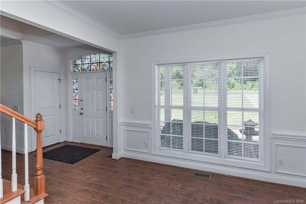 2425 Lakeview Circle Matthews, NC 28105 - Photo 5 of 33 a view of an empty room with wooden floor and a window