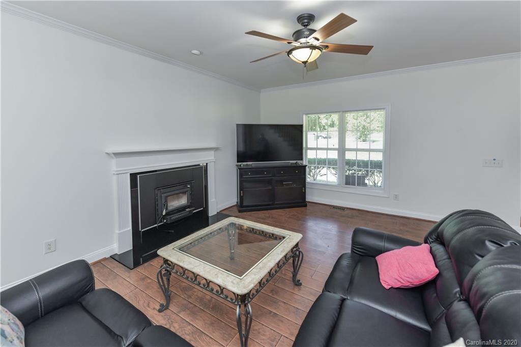 2425 Lakeview Circle Matthews, NC 28105 - Photo 7 of 33 a living room with furniture and a fireplace