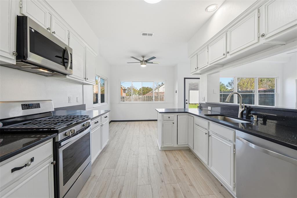 10120 Long Rifle Drive Fort Worth, TX 76108 - Photo 11 of 28 a kitchen with stainless steel appliances granite countertop a stove a sink and a microwave