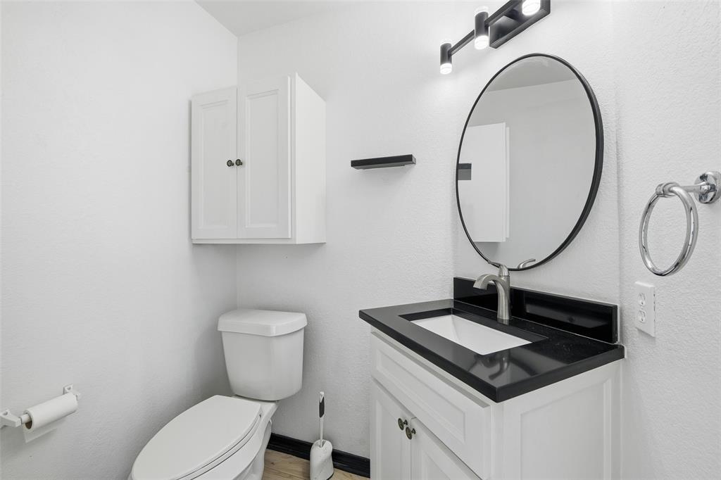 10120 Long Rifle Drive Fort Worth, TX 76108 - Photo 13 of 28 a bathroom with a toilet a sink and a mirror
