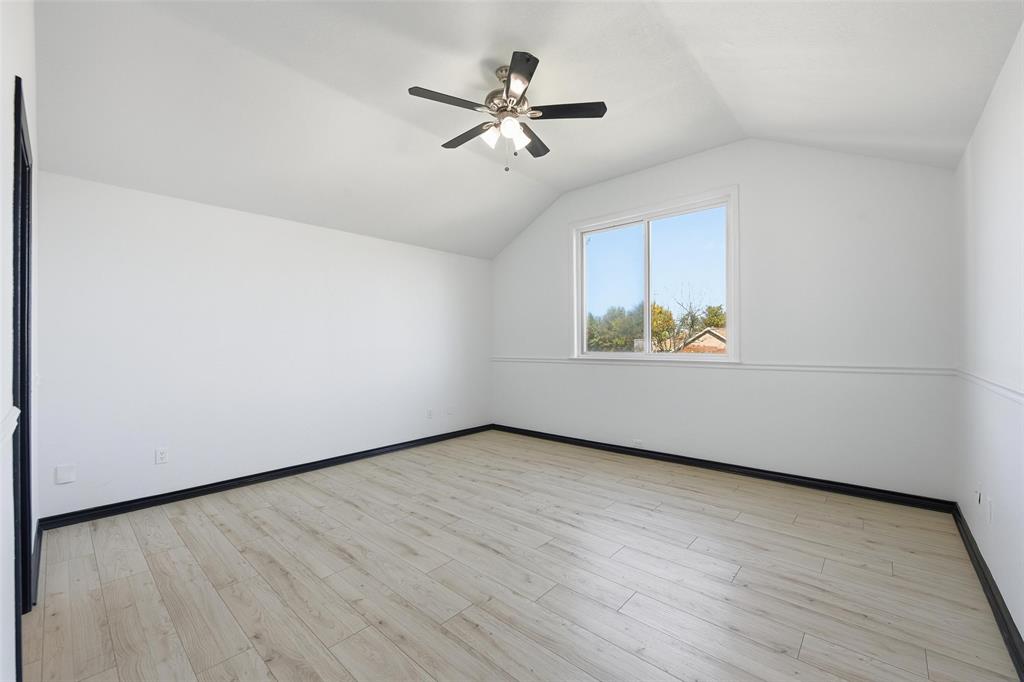 10120 Long Rifle Drive Fort Worth, TX 76108 - Photo 15 of 28 an empty room with wooden floor ceiling fan and windows