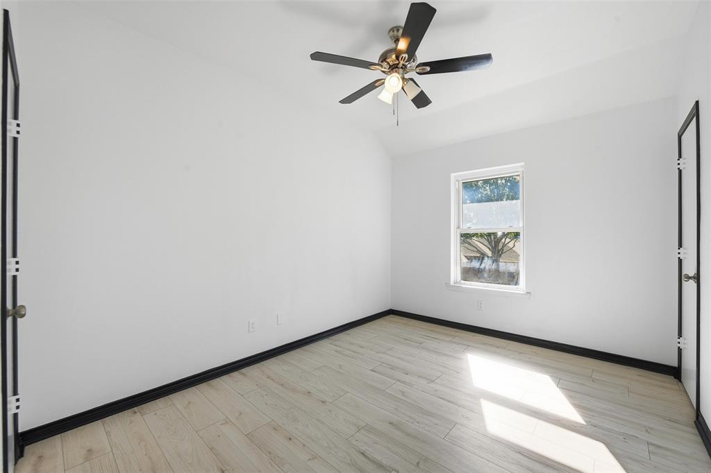 10120 Long Rifle Drive Fort Worth, TX 76108 - Photo 19 of 28 an empty room with wooden floor fan and windows
