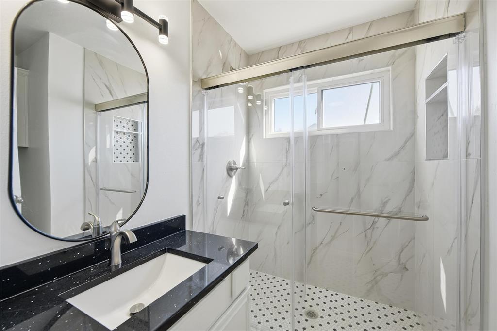 10120 Long Rifle Drive Fort Worth, TX 76108 - Photo 21 of 28 a bathroom with a sink a mirror and a shower