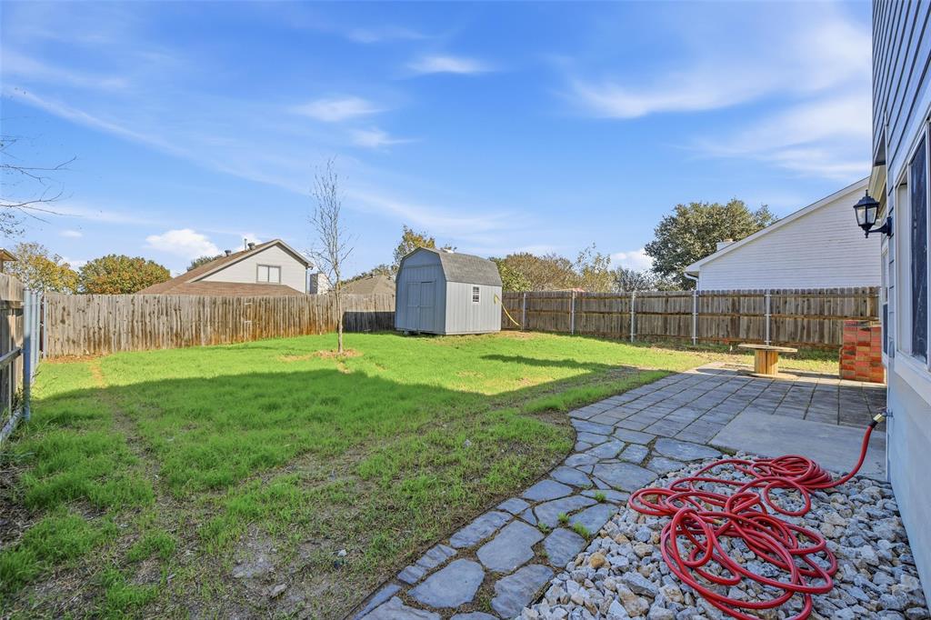 10120 Long Rifle Drive Fort Worth, TX 76108 - Photo 24 of 28 a view of a house with backyard and a garden