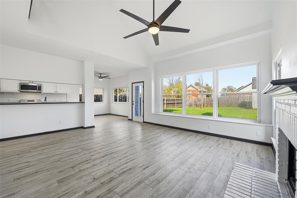 10120 Long Rifle Drive Fort Worth, TX 76108 - Photo 7 of 28 a view of an empty room with a window and wooden floor