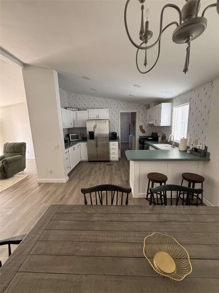 a kitchen with stainless steel appliances granite countertop a sink a stove and cabinets