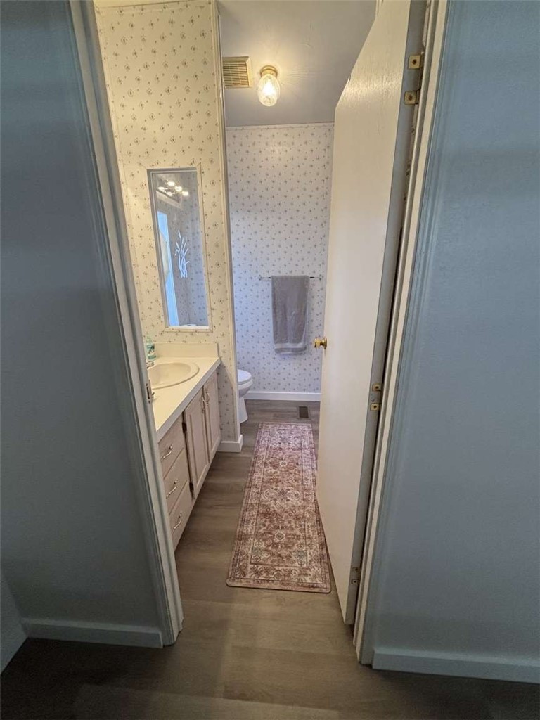 1770 Riviera Drive Blythe, CA 92225 - Photo 12 of 23 a view of a hallway with wooden floor and staircase