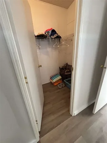 a white bath tub sitting under a shower curtain