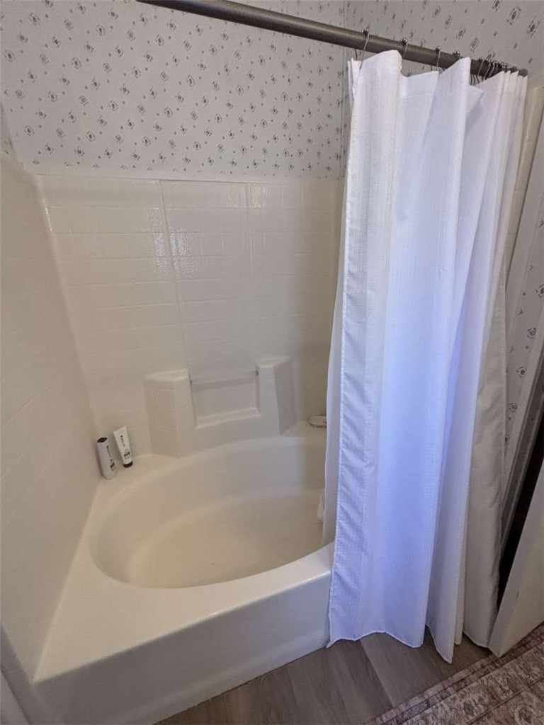 1770 Riviera Drive Blythe, CA 92225 - Photo 14 of 23 a white bath tub sitting under a shower curtain