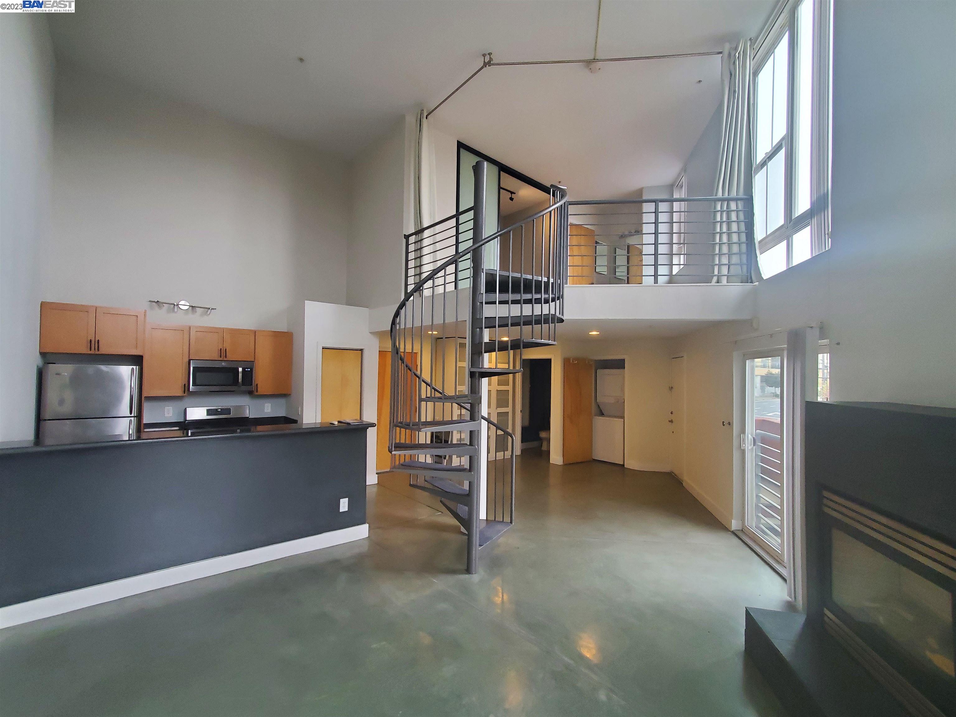 a view of a livingroom with furniture and a hallway