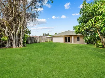 a view of an house with backyard space and garden