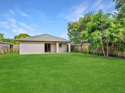 a view of a house with garden and yard
