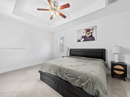 a bedroom with a bed and a chandelier