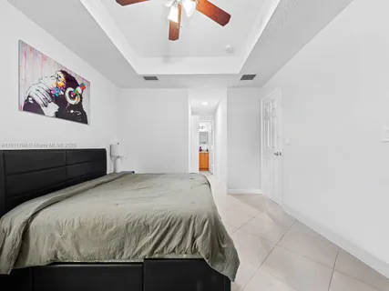 a bedroom with a bed and a painting on the wall