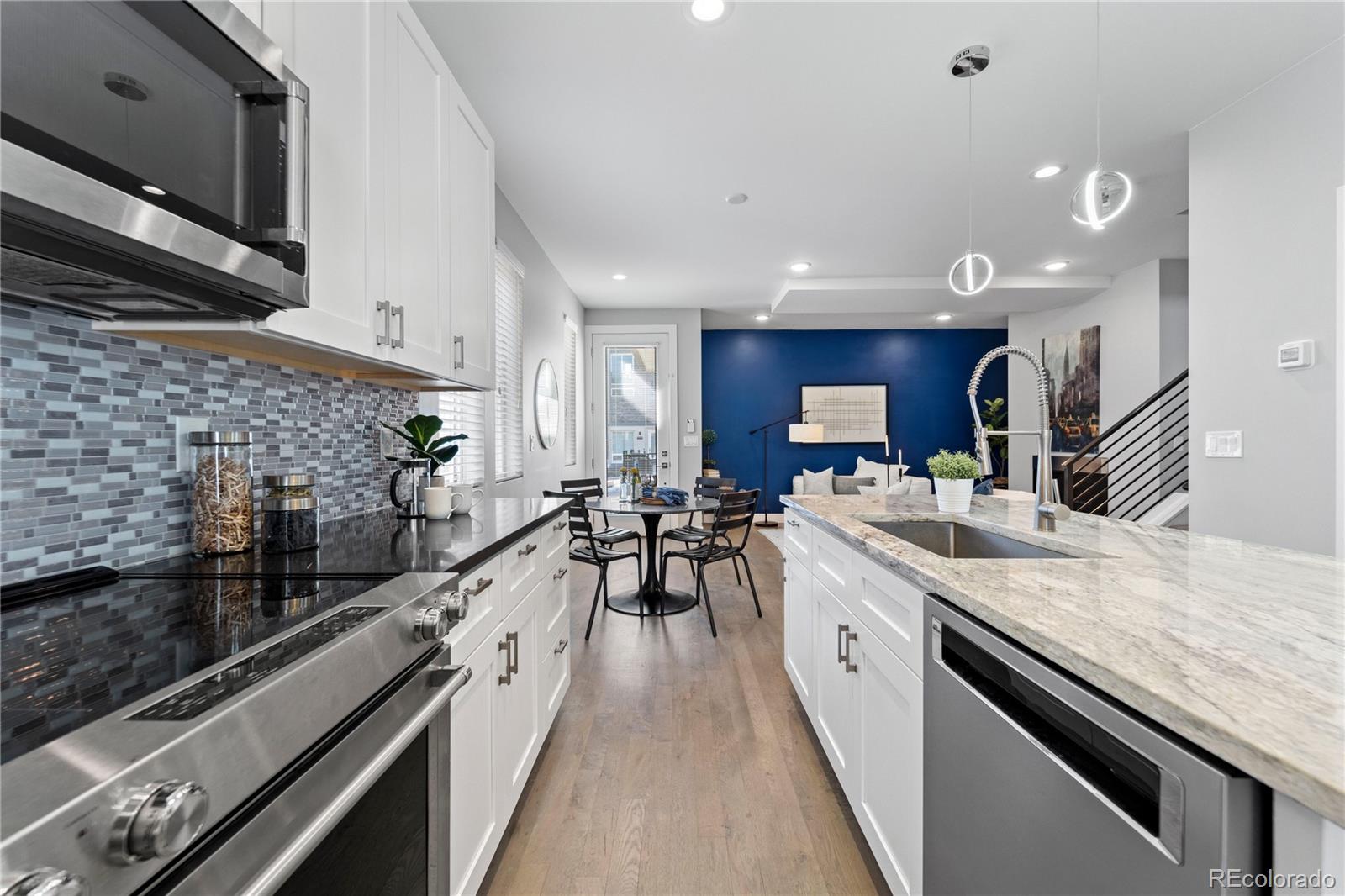 a large kitchen with stainless steel appliances granite countertop a lot of counter space