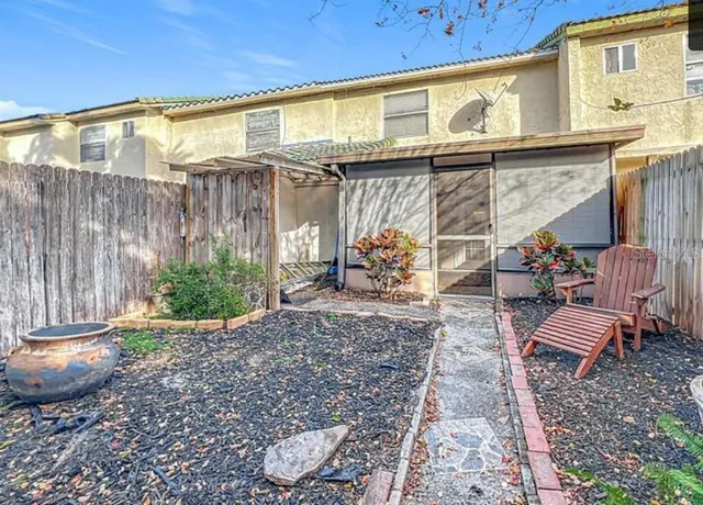 a view of a backyard with plants and a patio