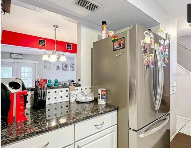 a kitchen with refrigerator and window