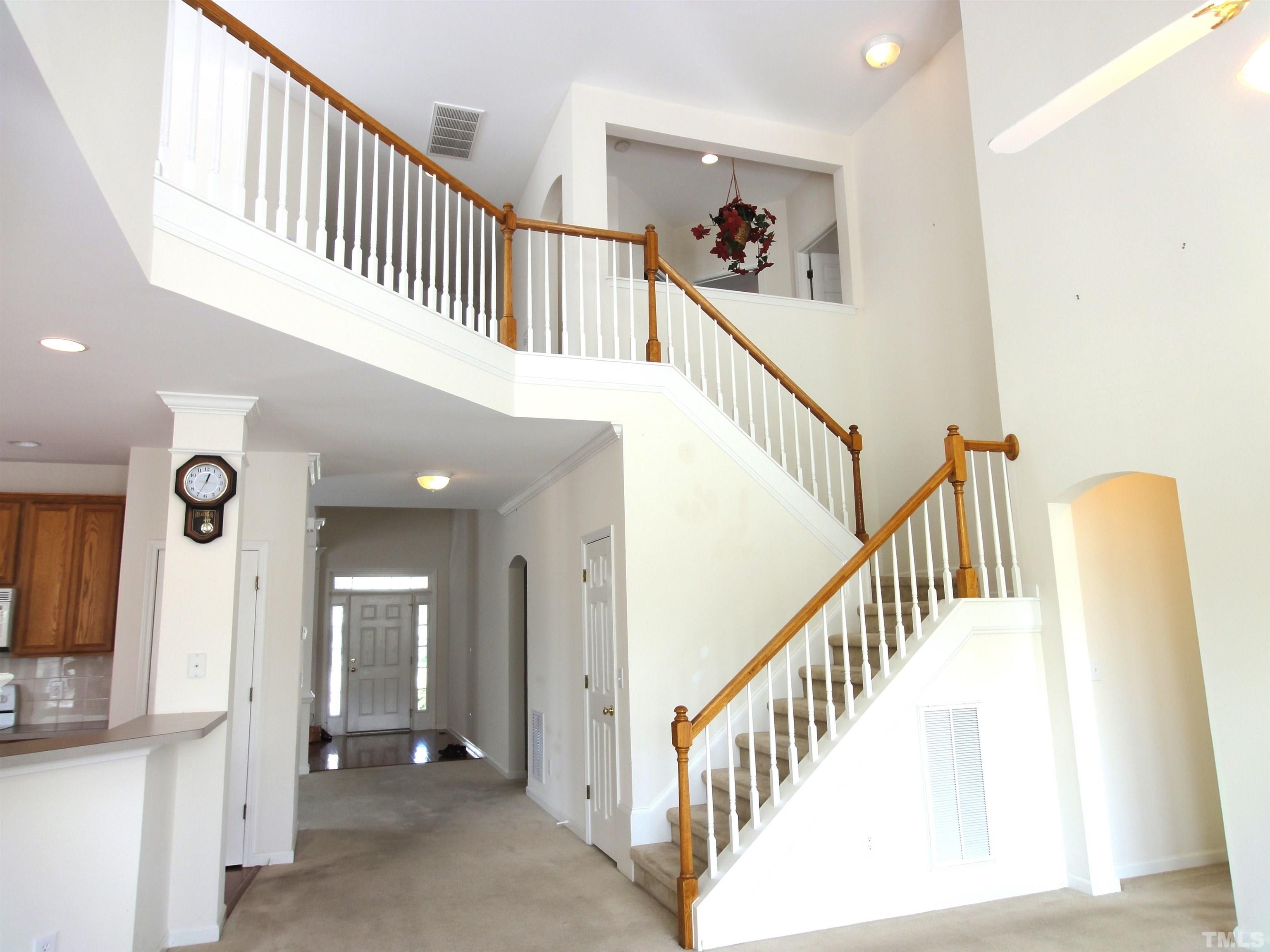 123 North Fields Circle Chapel Hill, NC 27516 - Photo 18 of 24 a view of staircase with lots of frames on wall and a view of a hallway