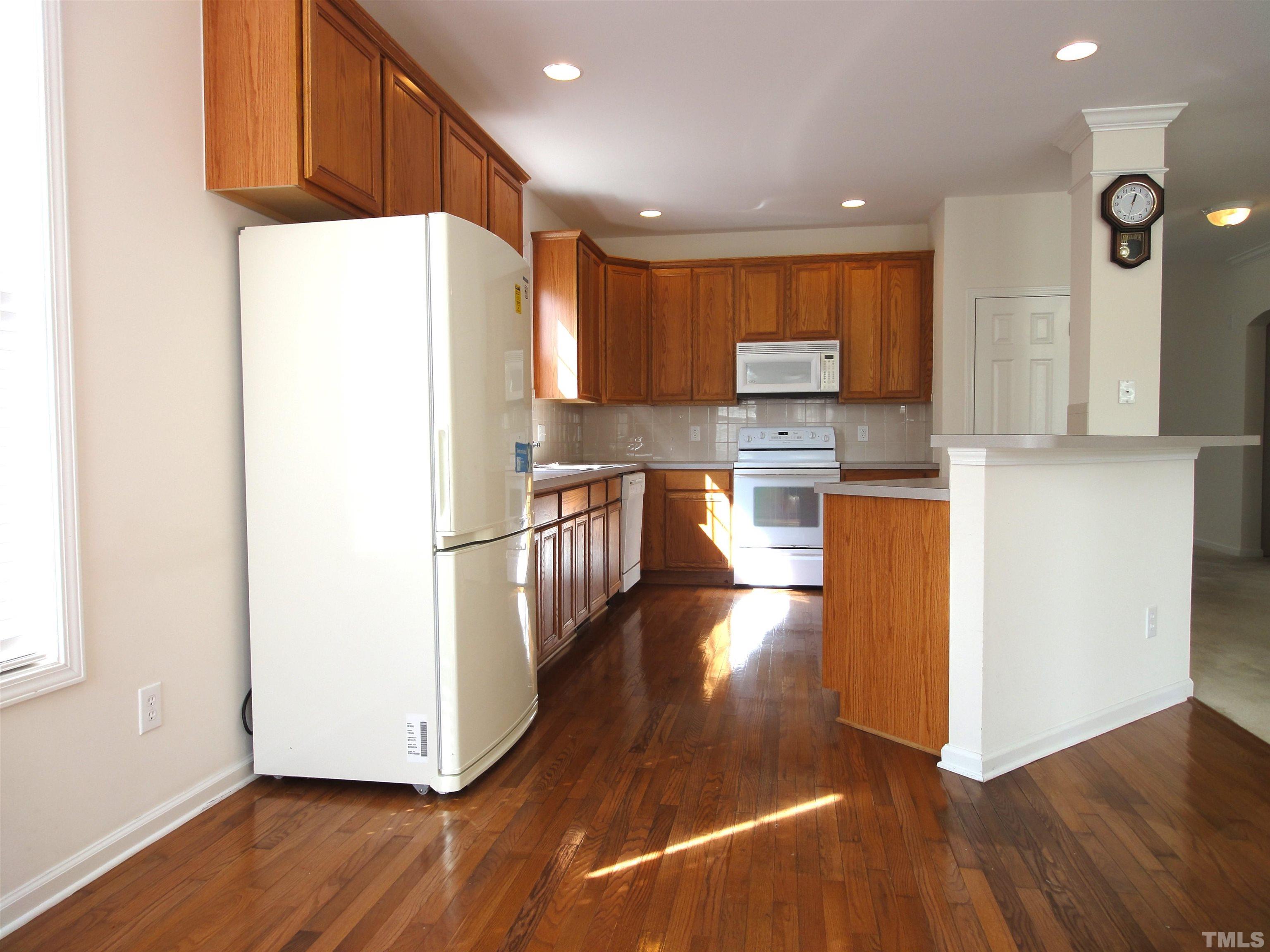 123 North Fields Circle Chapel Hill, NC 27516 - Photo 4 of 24 a kitchen with granite countertop a refrigerator and a stove top oven