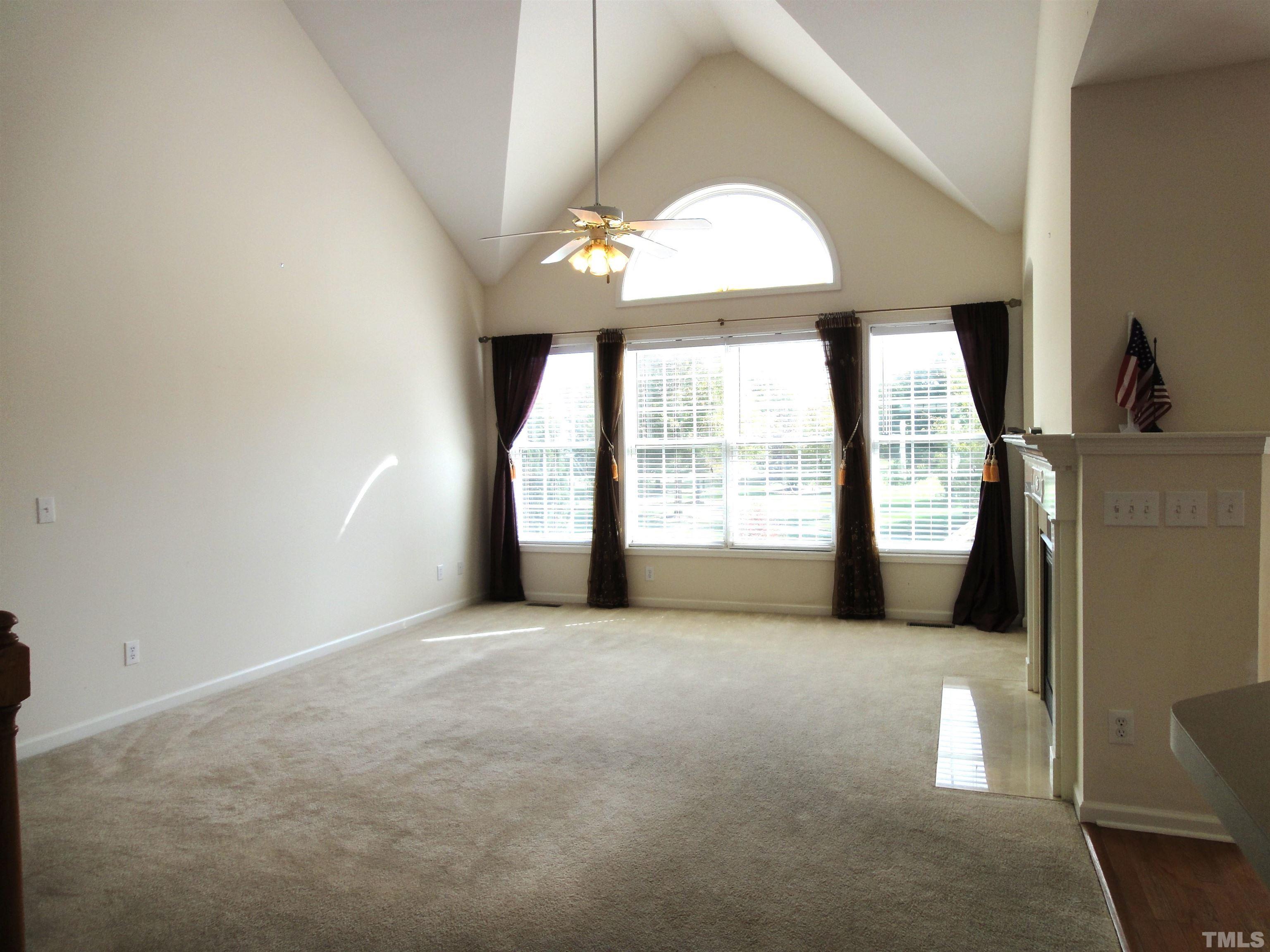 123 North Fields Circle Chapel Hill, NC 27516 - Photo 5 of 24 an empty room with a fireplace and windows