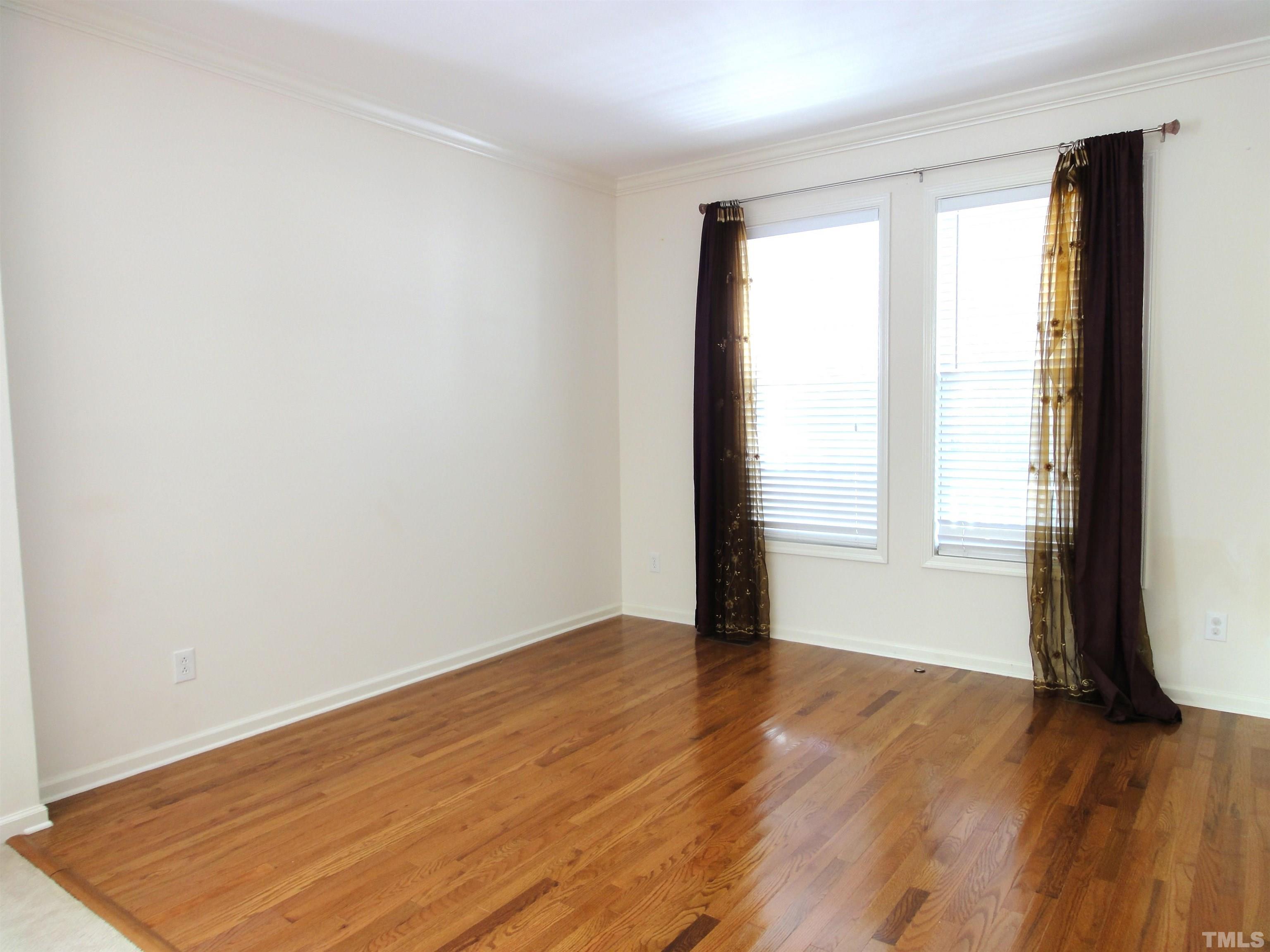 123 North Fields Circle Chapel Hill, NC 27516 - Photo 7 of 24 an empty room with wooden floor and windows