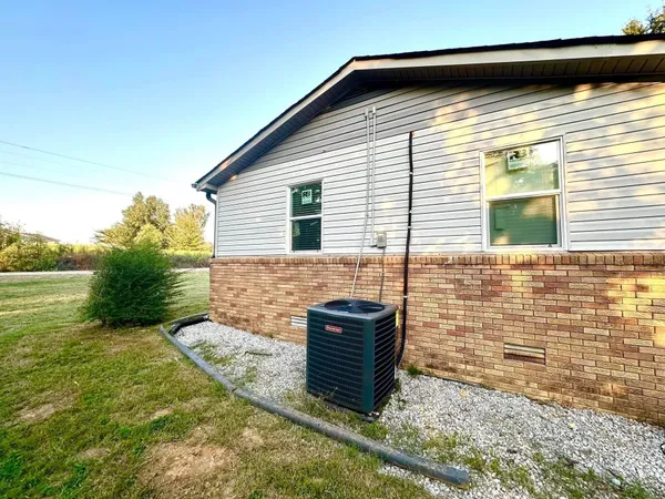 a backyard of a house with barbeque oven