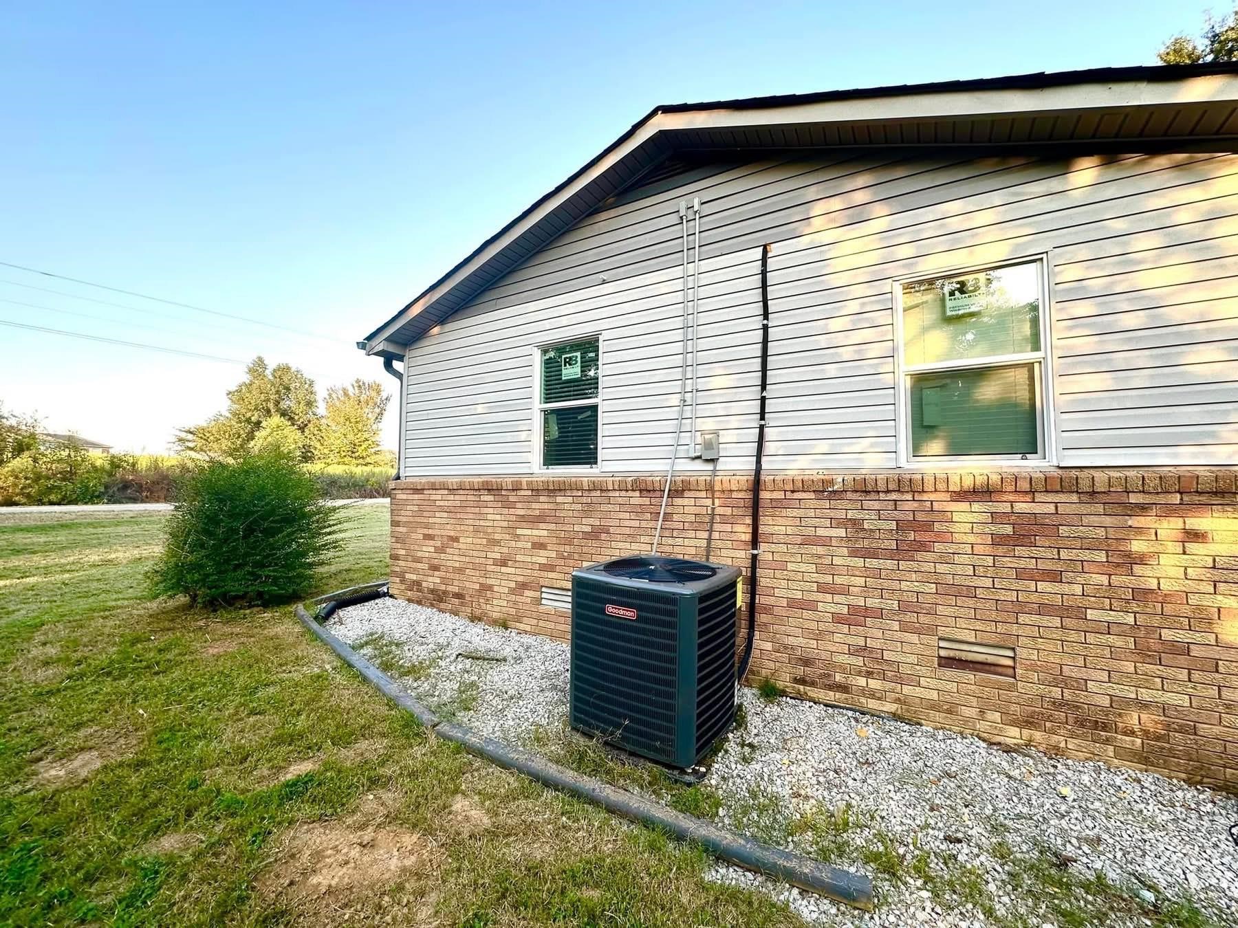 2003 Bond Ferry Road Brownsville, TN 38012 - Photo 15 of 16 View of side of home featuring brick siding, a yard, and crawl space
