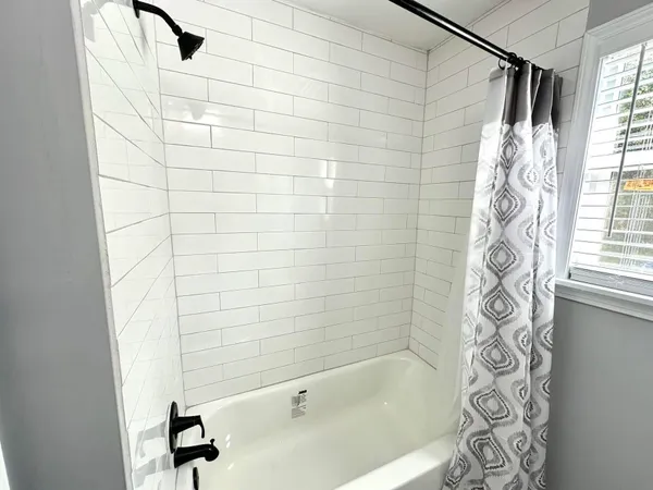 a bathroom with a bathtub and shower