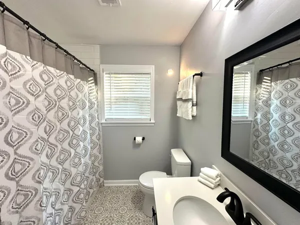 a bathroom with a toilet a sink and a shower