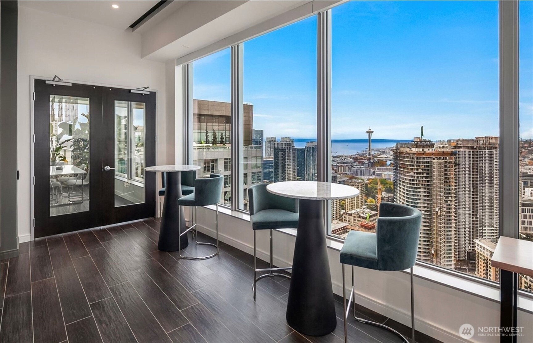 1808 Minor Avenue, Unit 912 Seattle, WA 98101 - Photo 24 of 39 a view of a living room with a floor to ceiling window and wooden floor