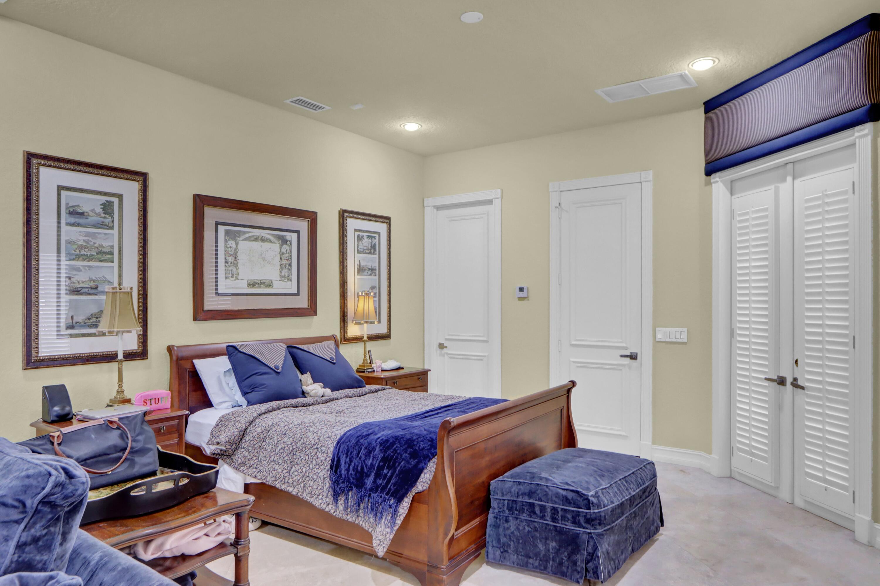 3799 Northwest Coventry Lane Boca Raton, FL 33496 - Photo 24 of 49 a spacious bedroom with a bed and furniture