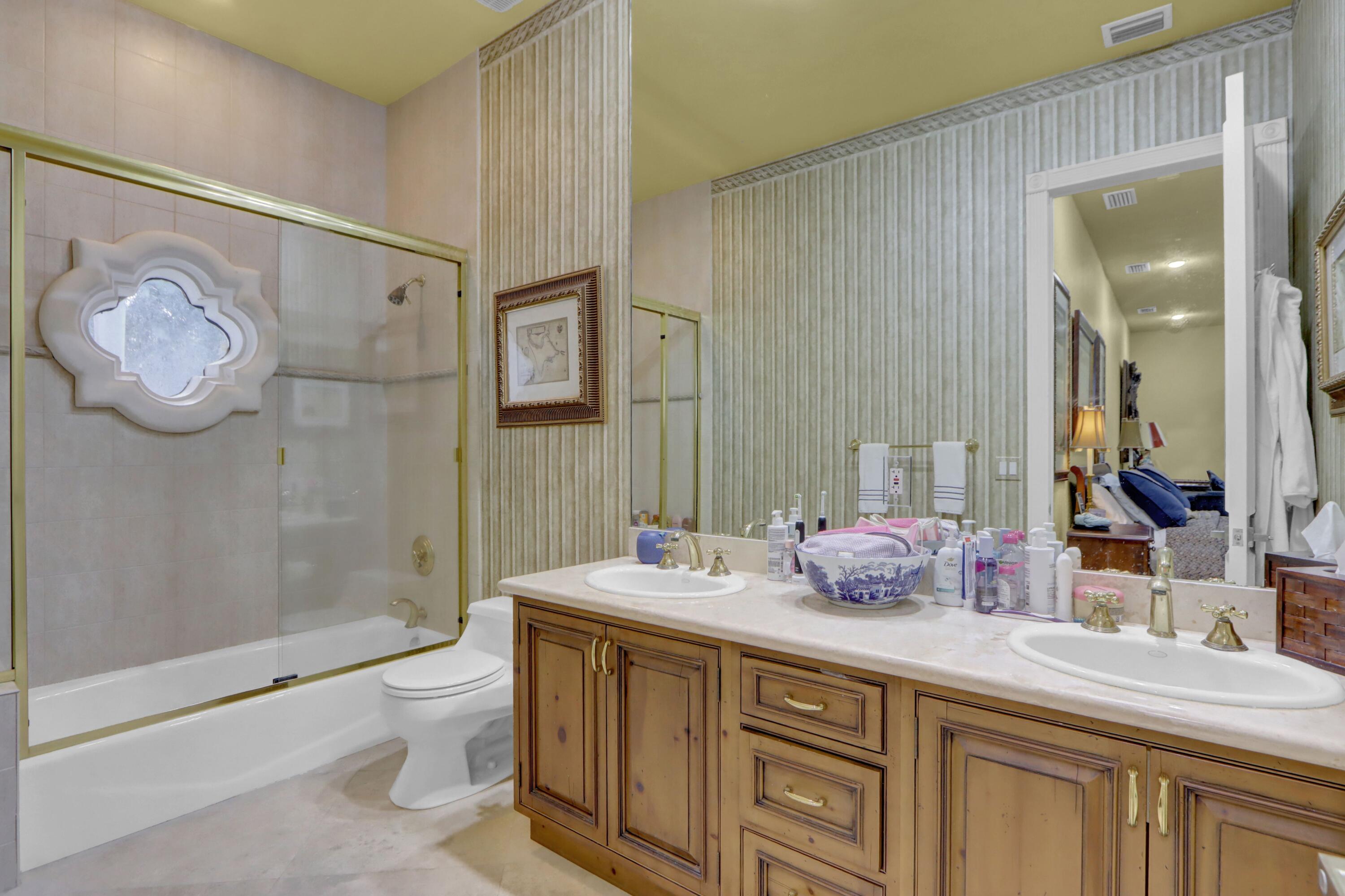 3799 Northwest Coventry Lane Boca Raton, FL 33496 - Photo 26 of 49 a bathroom with a granite countertop sink a toilet and shower