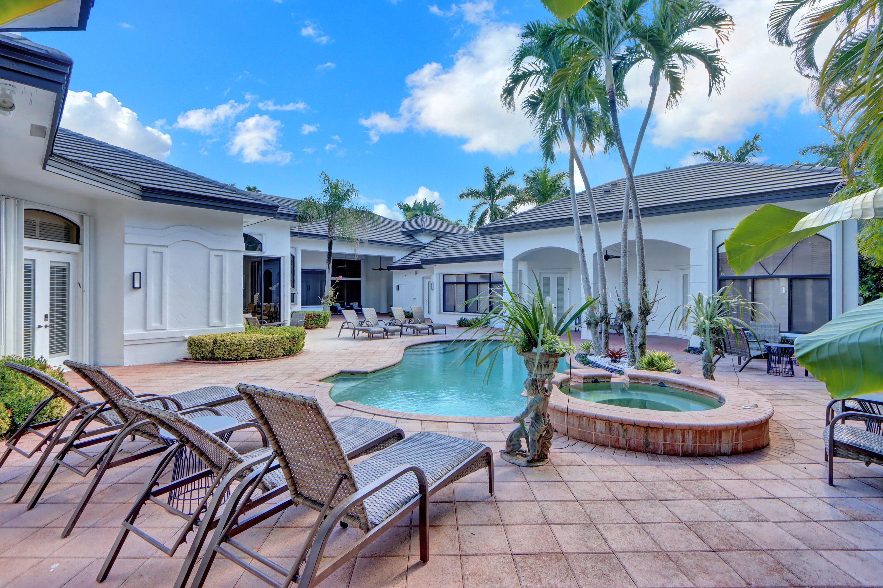 3799 Northwest Coventry Lane Boca Raton, FL 33496 - Photo 29 of 49 a view of a chair and table in backyard of the house