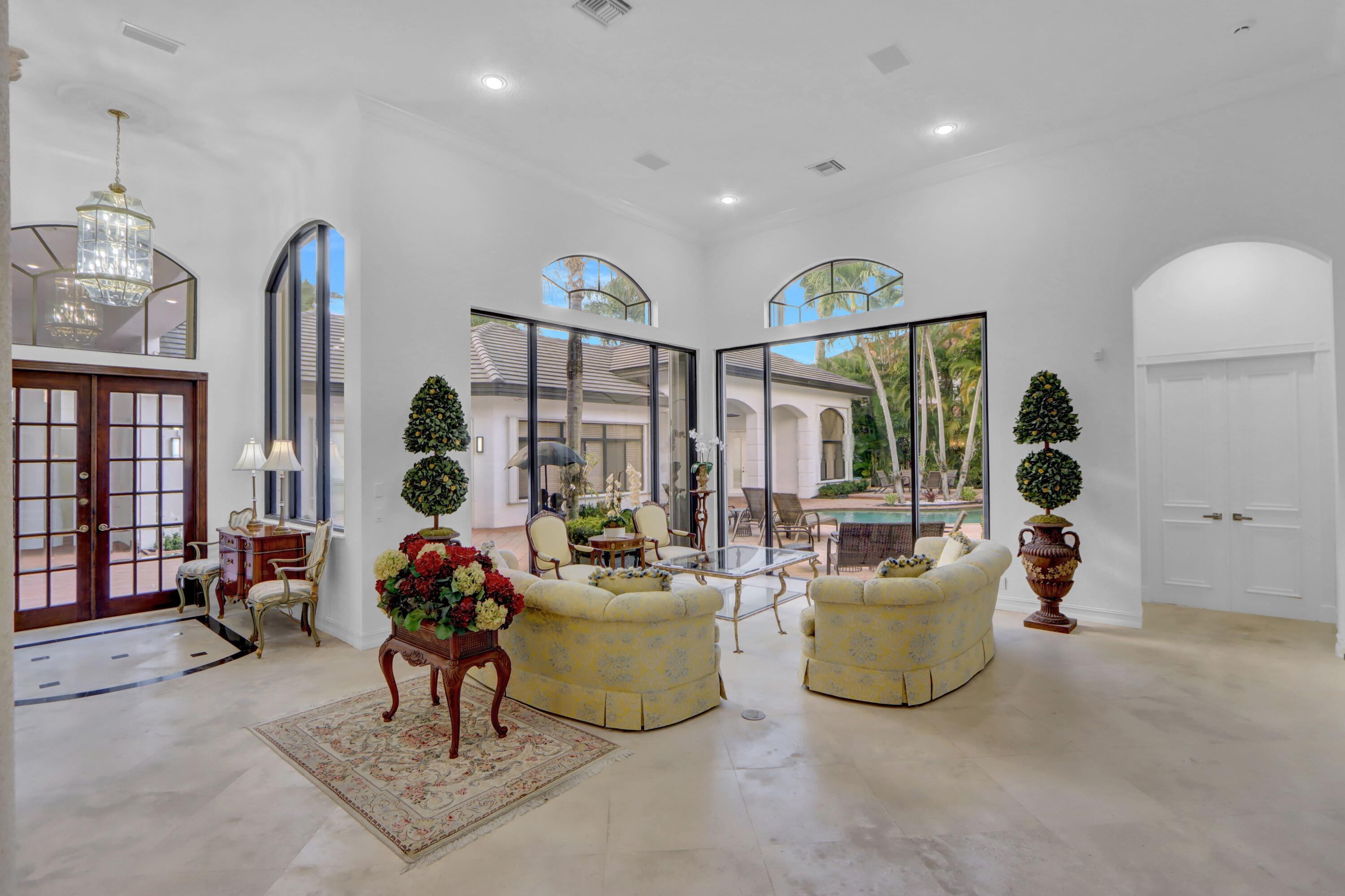 3799 Northwest Coventry Lane Boca Raton, FL 33496 - Photo 3 of 49 a living room with furniture a chandelier and a potted plant