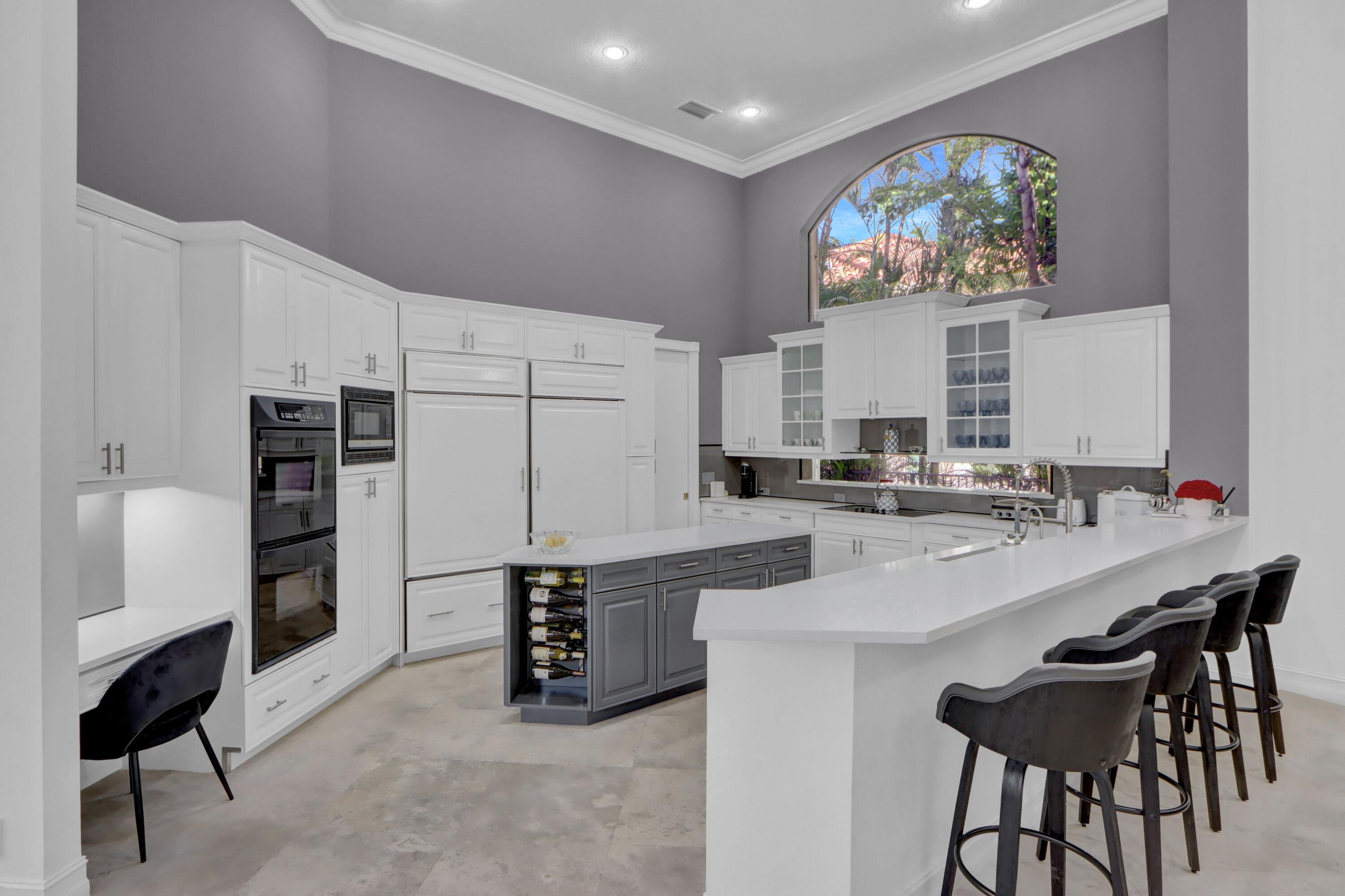 3799 Northwest Coventry Lane Boca Raton, FL 33496 - Photo 8 of 49 a kitchen with stainless steel appliances a microwave a stove and white cabinets