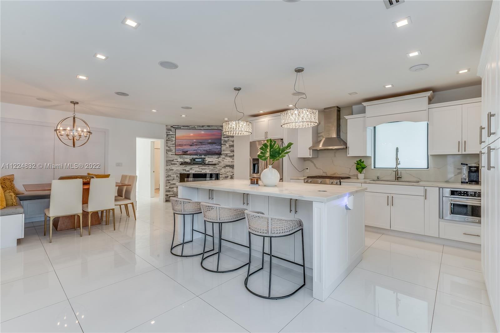 401 Southwest 23rd Road Miami, FL 33129 - Photo 11 of 25 a kitchen with stainless steel appliances kitchen island granite countertop a sink and cabinets