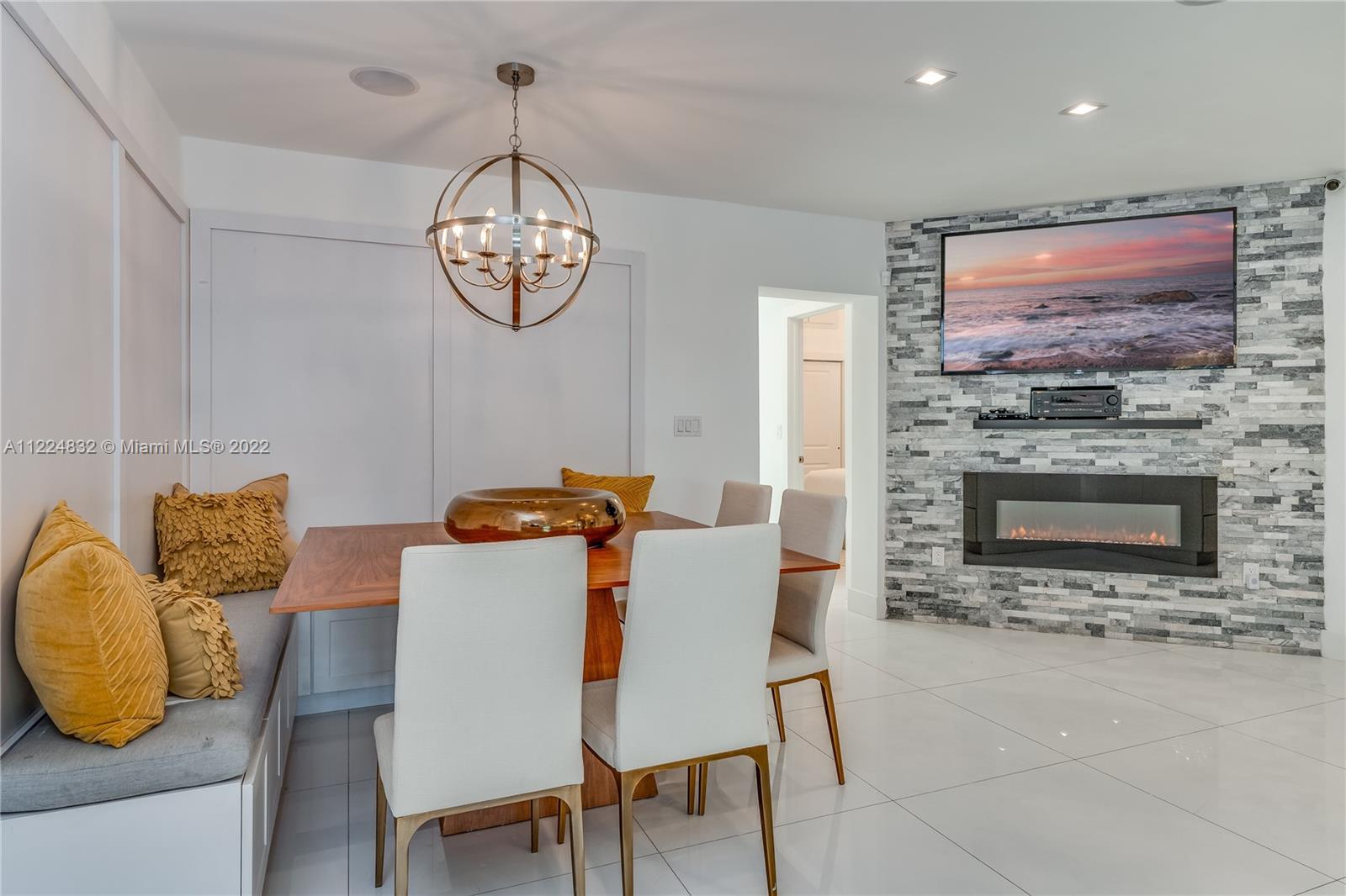 401 Southwest 23rd Road Miami, FL 33129 - Photo 17 of 25 a dining room with furniture a fireplace and a flat screen tv