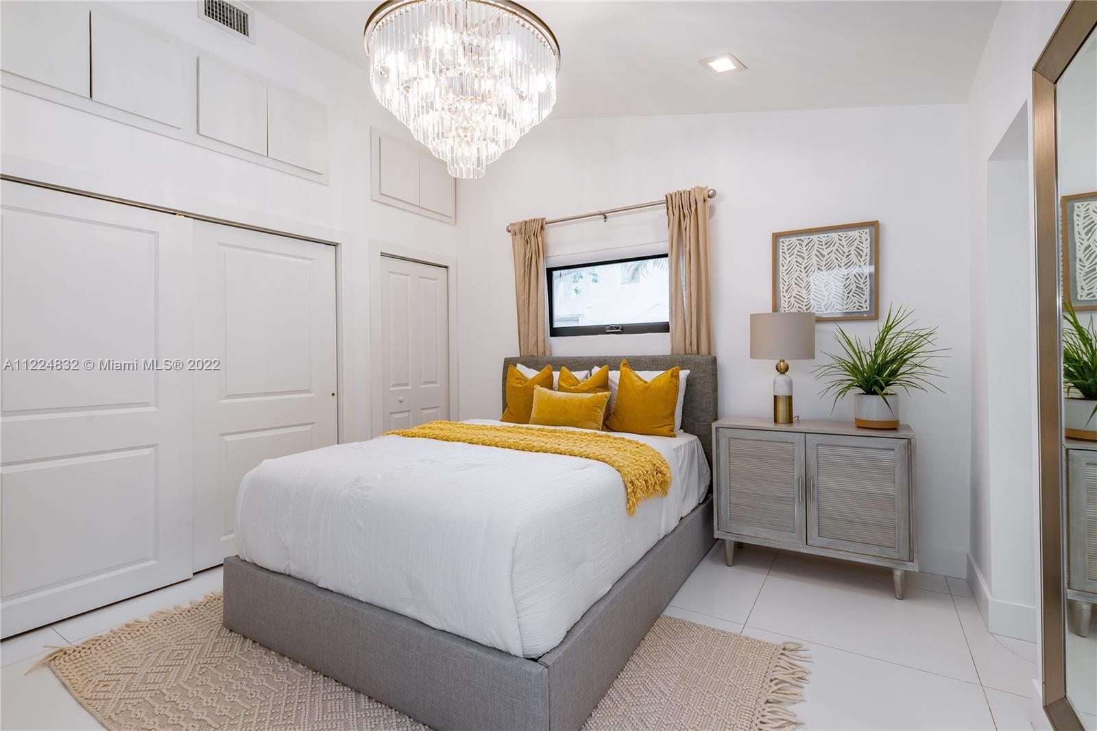 401 Southwest 23rd Road Miami, FL 33129 - Photo 18 of 25 a bedroom with a bed and a chandelier