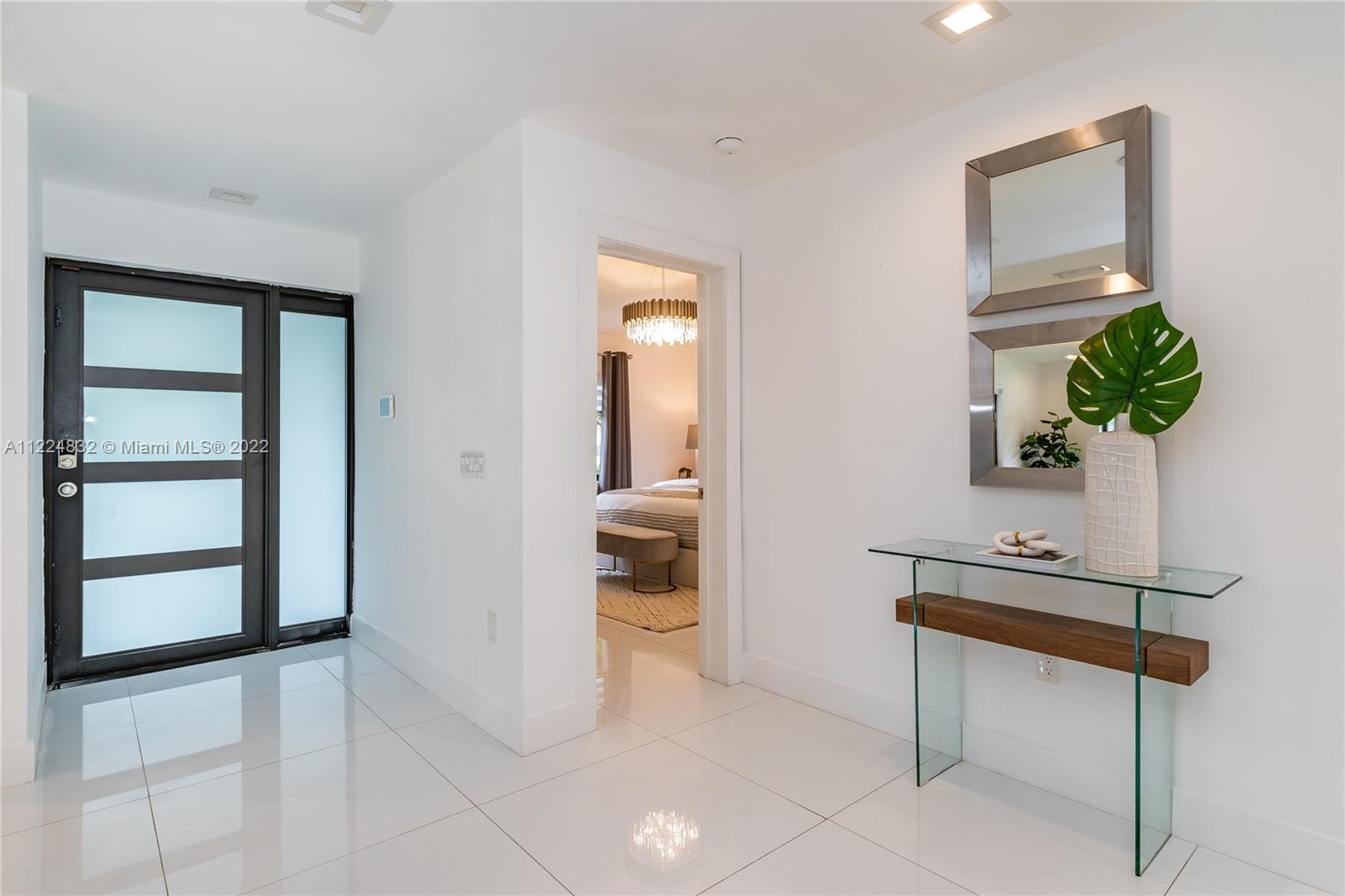401 Southwest 23rd Road Miami, FL 33129 - Photo 7 of 25 a hallway with a table and a potted plant