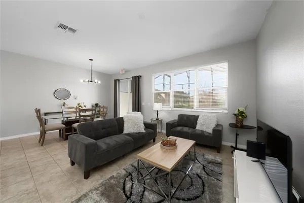 a kitchen with stainless steel appliances kitchen island granite countertop a refrigerator a stove a sink and a microwave