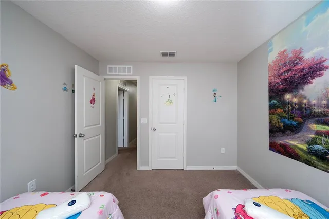 a bedroom with a bed and a table in it