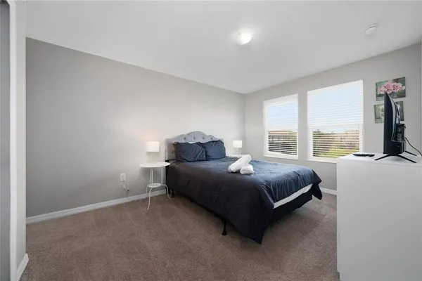 a bedroom with a bed and a chair