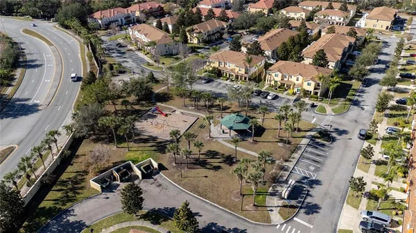 an aerial view of a house with a yard and large trees