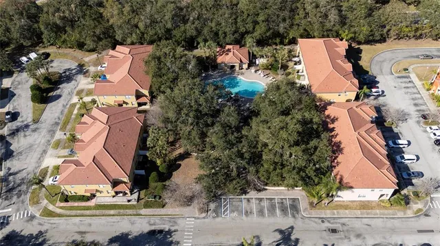 an aerial view of a house with a yard and trees