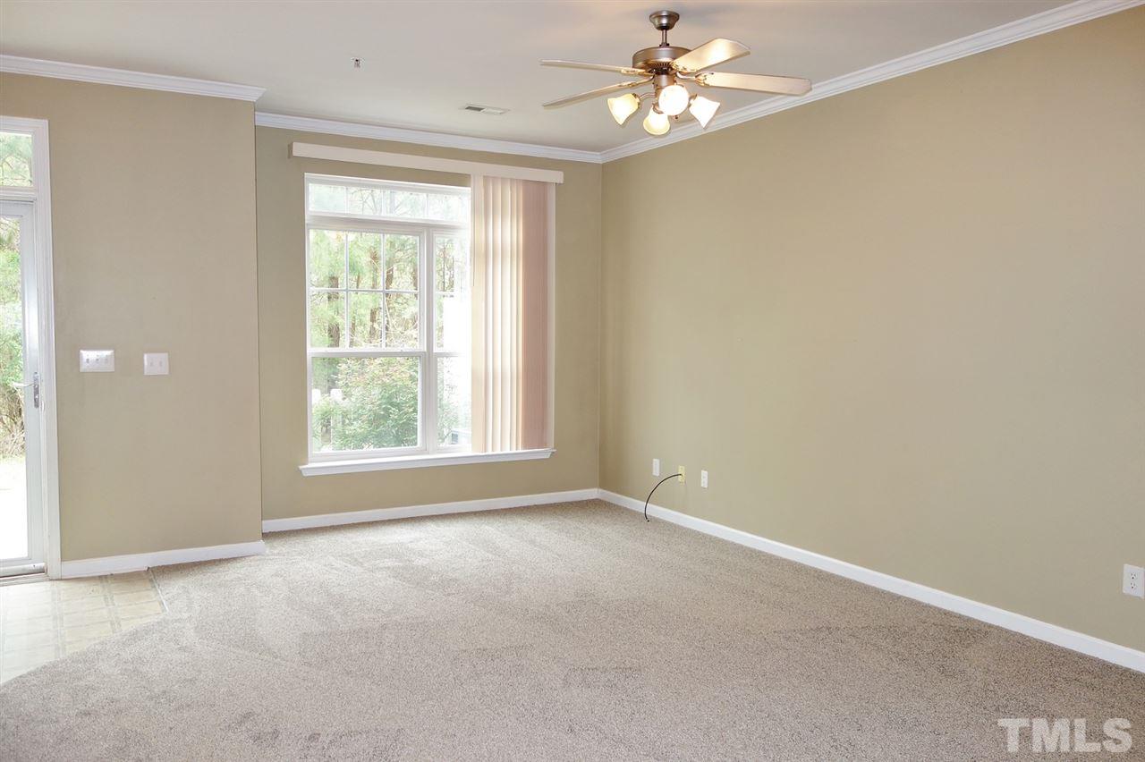 2225 Raven Road, Unit 105 Raleigh, NC 27614 - Photo 2 of 16 an empty room with a window and a fan
