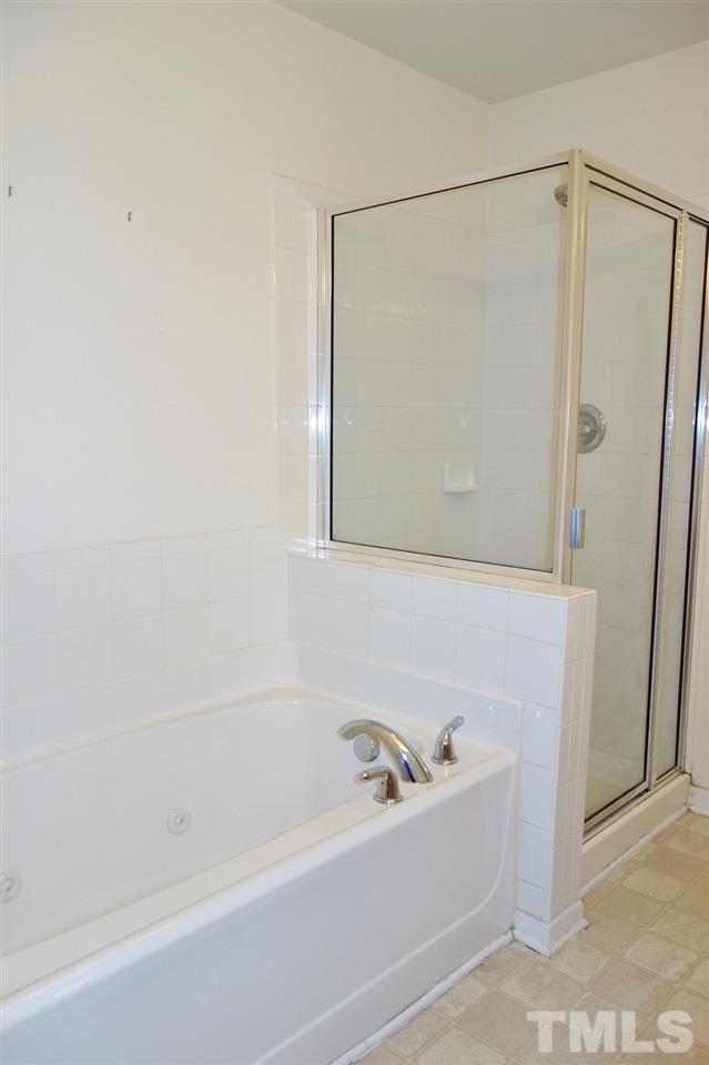2225 Raven Road, Unit 105 Raleigh, NC 27614 - Photo 11 of 16 a bathroom with a bathtub and a shower